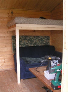 Cabin interior-Alex's home made sleeping loft, with the couch underneath, and power tools in the foreground!